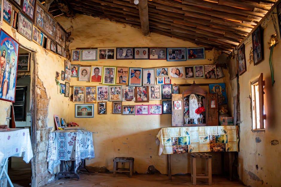 A rustic room filled with vintage family photos and wall decor, radiating nostalgia and warmth.