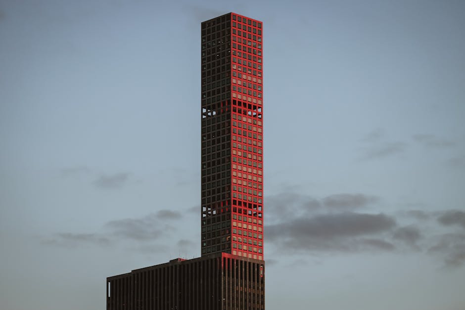 A striking view of a modern skyscraper in New York City illuminated during the golden hour.