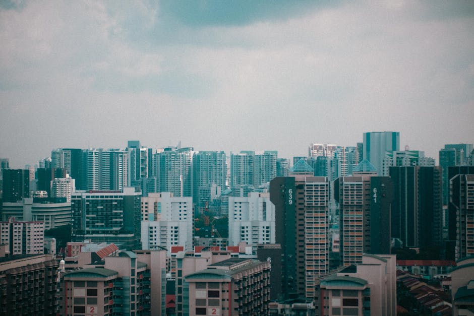 A stunning cityscape view of Singapore's high-rise buildings under a cloudy sky, showcasing urban architecture.