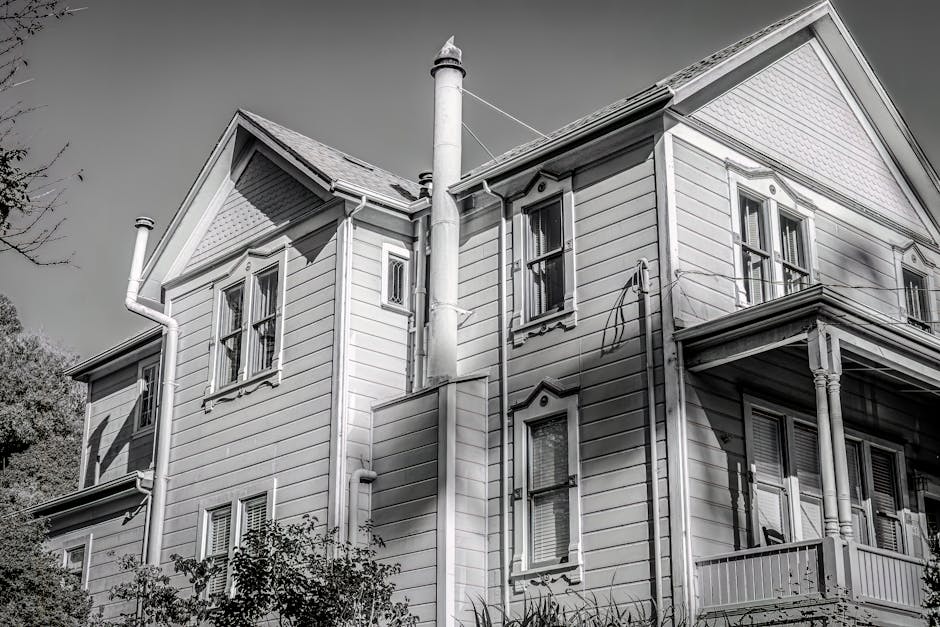 Elegant facade of a vintage family house captured in black and white.