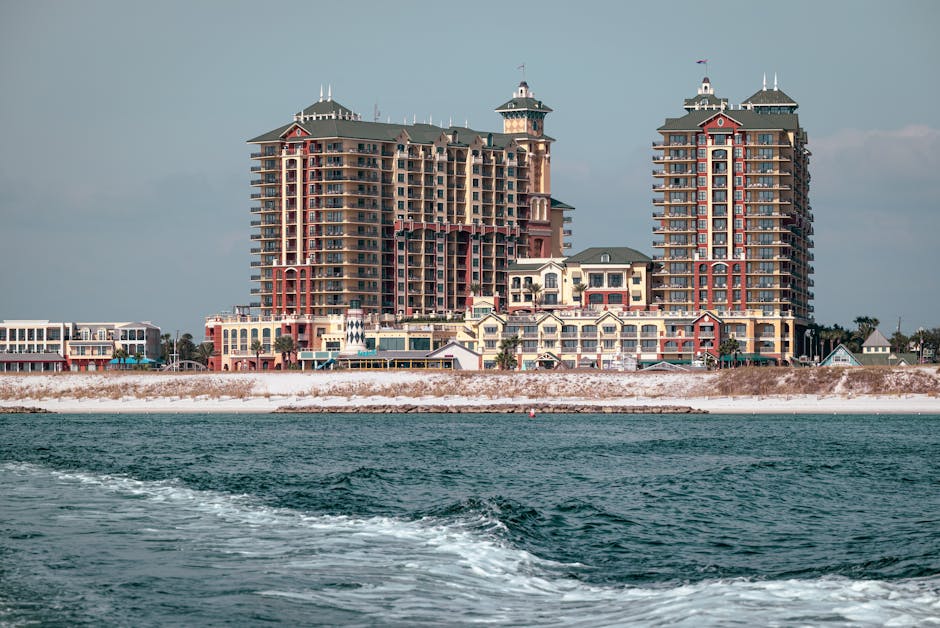 Elegant waterfront buildings overlooking a serene coastal view, perfect for real estate opportunities.