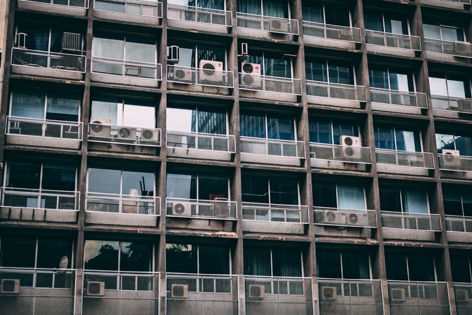 Exterior view of a residential building with multiple air conditioners, reflecting urban life in Sao Paulo.