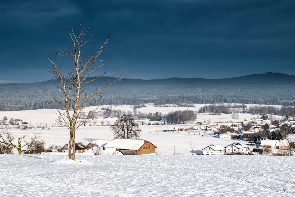 Snow-covered countryside and village under a dramatic sky in Upper Austria.
